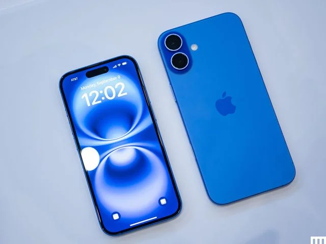 2 of the same thin blue mobile phone one laying screen side up and the other laying camera side up