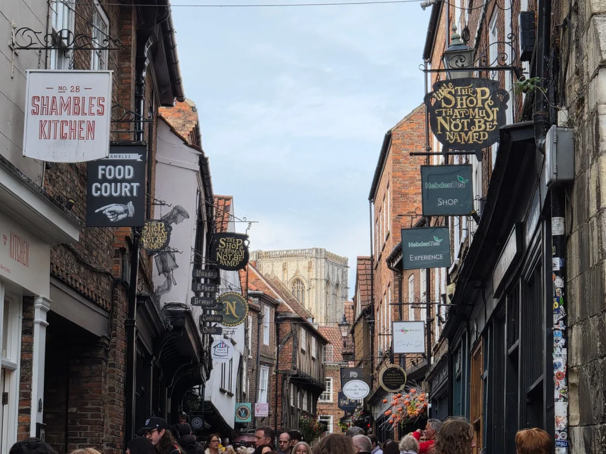 Image may contain City Road Street Urban Arch Architecture Gothic Arch Person Alley Clothing Hat and Accessories
