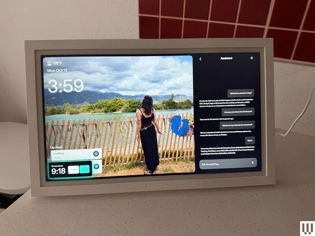 Small digital screen on top of a countertop showing a photo and a chat assistant