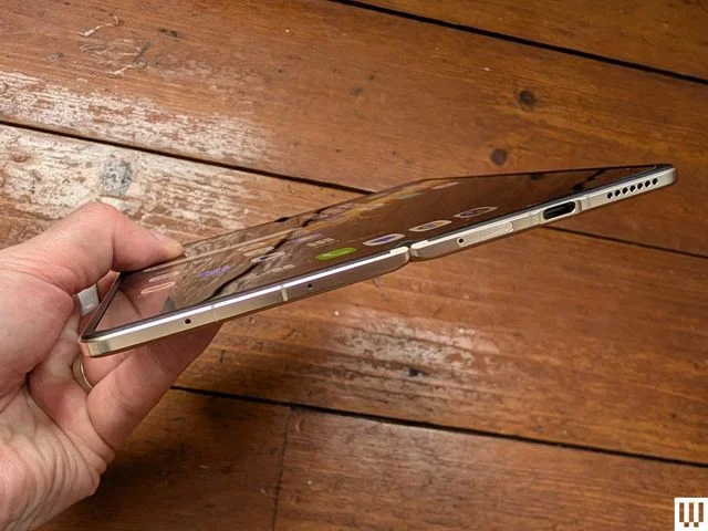 Image may contain Electronics Phone Mobile Phone Computer Laptop Pc Person and Iphone