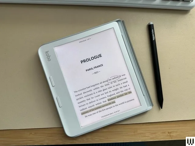 Overhead view of Kobo Libra Color, a light teal digital notebook and pen (stylus)